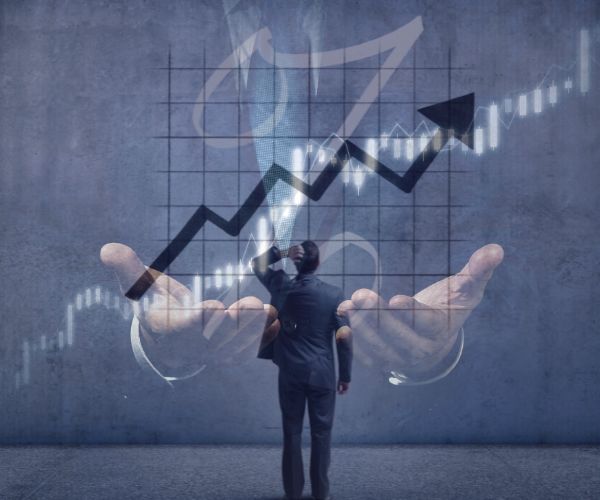 Ratefxbroker - home page section 1 Businessman analyzing a rising graph with financial data, superimposed over an image of hands holding the graph, symbolizing financial growth and support.